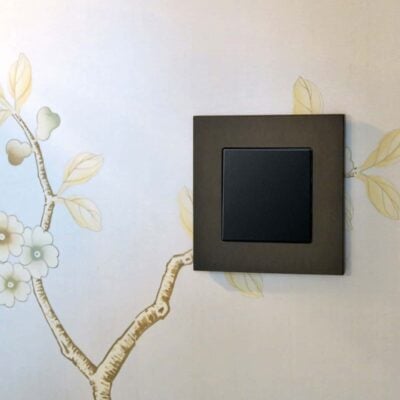 GIRA Esprit Dark Bronze light switch on patterned wall