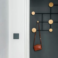 Jung Les Couleurs light switch in gris fonce in a hallway