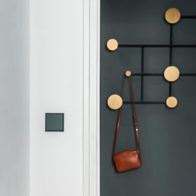 Jung Les Couleurs light switch in gris fonce in a hallway